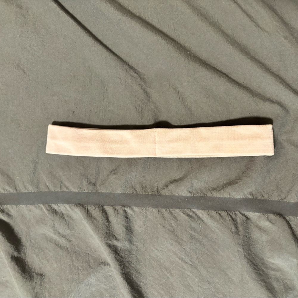 It is a lululemon headband. The color is strawberry milkshake.